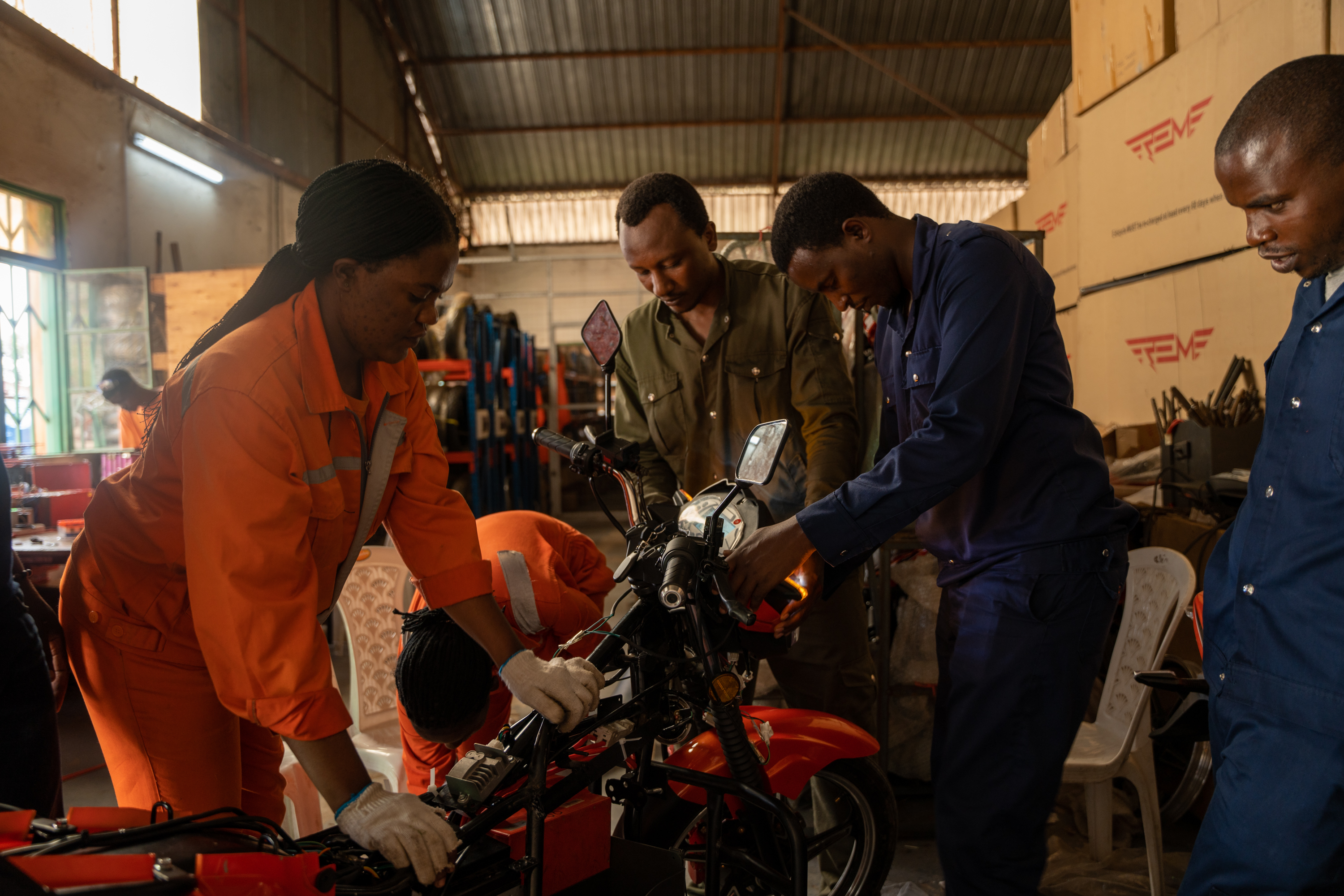 Women and men working on a motorcycle