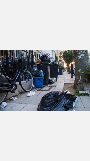 a street with trash bags