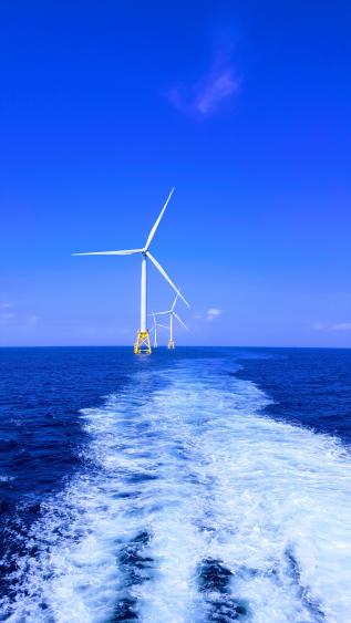 Photo of wind turbine in sea by Shaun Dakin on Unsplash